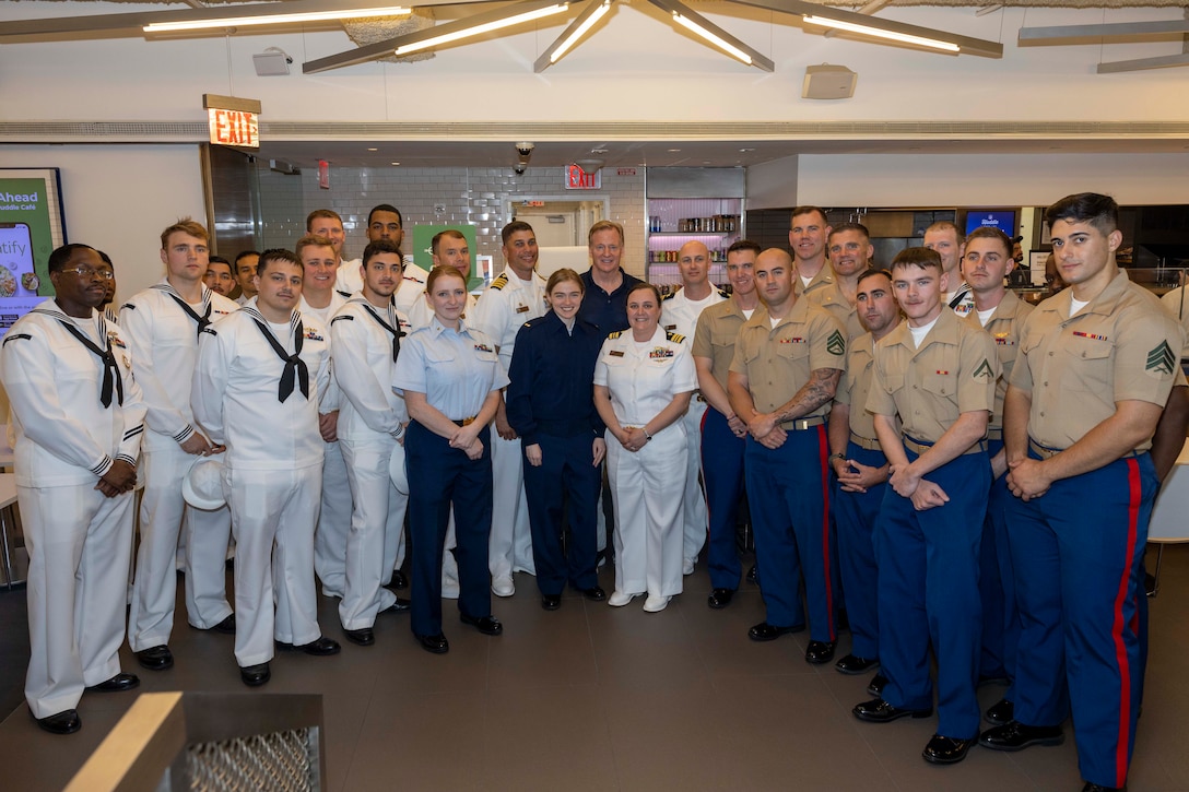Marines, Sailors and Coast Guardsmen pose for a group photo with National Football League (NFL) Commissioner Roger Godell, center, during a tour at the NFL Headquarters as part of Fleet Week New York (FWNY), May 25, 2023. During FWNY 2023, more than 3,000 service members from the Marine Corps, Navy and Coast Guard and our NATO allies from Great Britain, Italy and Canada are engaging in special events throughout New York City and the surrounding Tri-State Region, showcasing the latest capabilities of today’s maritime services and connecting with citizens. These events include free public ship tours, military static displays, and live band performances and parades. (Photo by Mass Communication Specialist 1st Class Pedro A. Rodriguez)