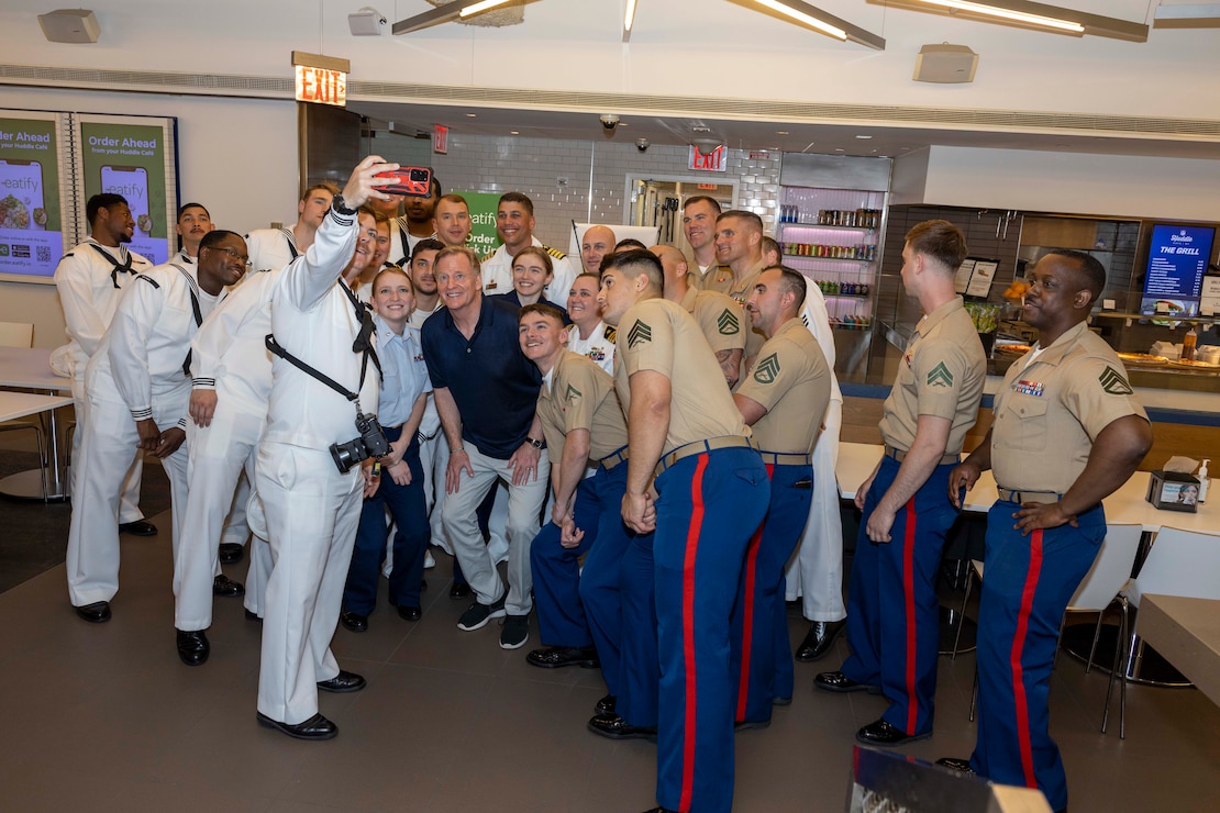 Marines, Sailors and Coast Guardsmen take a selfie with National Football League (NFL) Commissioner Roger Godell, center, during a tour at the NFL Headquarters as part of Fleet Week New York (FWNY), May 25, 2023. During FWNY 2023, more than 3,000 service members from the Marine Corps, Navy and Coast Guard and our NATO allies from Great Britain, Italy and Canada are engaging in special events throughout New York City and the surrounding Tri-State Region, showcasing the latest capabilities of today’s maritime services and connecting with citizens. These events include free public ship tours, military static displays, and live band performances and parades. (Photo by Mass Communication Specialist 1st Class Pedro A. Rodriguez)