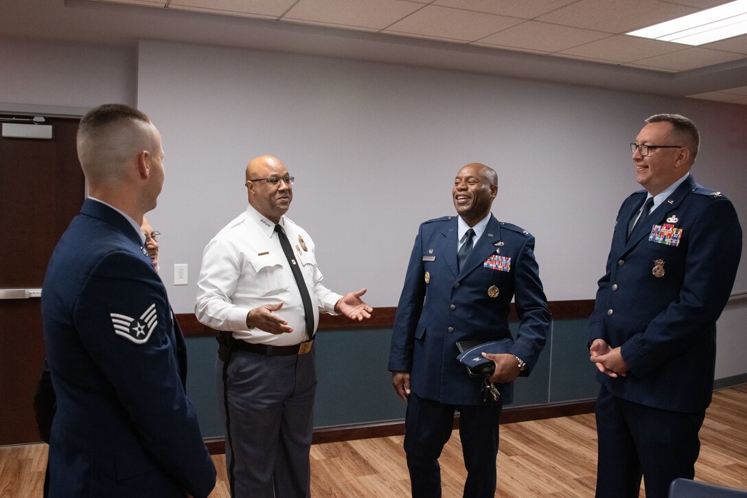 Malik Aziz, Prince George's County chief of police, third from right, speaks with 316th Wing Airmen during a Military Appreciation Month event at PGPD Headquarters in Upper Marlboro, Md., May 25, 2023. The PGPD held a Military Appreciation Month event to honor the Airmen and recognize the partnership between the department and the base. (U.S. Air Force photo by Senior Airman Daekwon Stith)