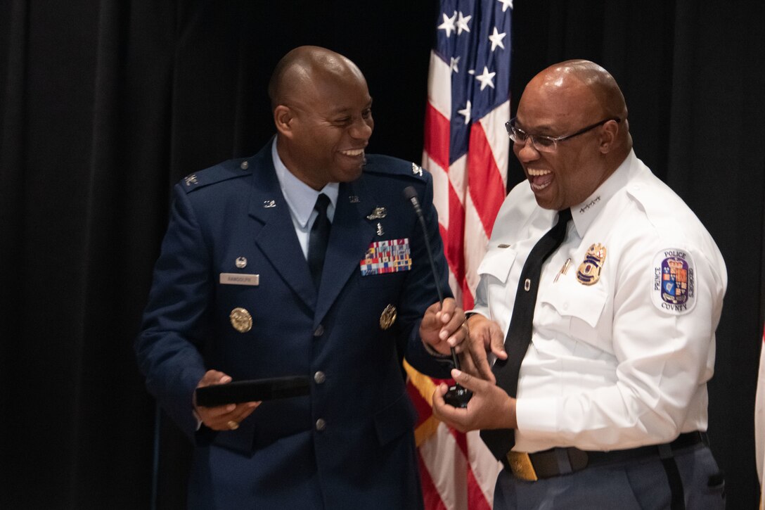 U.S. Air Force Col. Todd E. Randolph, left, 316th Wing and installation commander at Joint Base Andrews, Md., accepts a gift of appreciation from Malik Aziz, Prince George's County chief of police, during a Military Appreciation Month event at PGPD Headquarters in Upper Marlboro, Md., May 25, 2023. Security Forces Airmen assigned to the 316th Wing frequently work with PGPD during training and operations. (U.S. Air Force photo by Senior Airman Daekwon Stith)