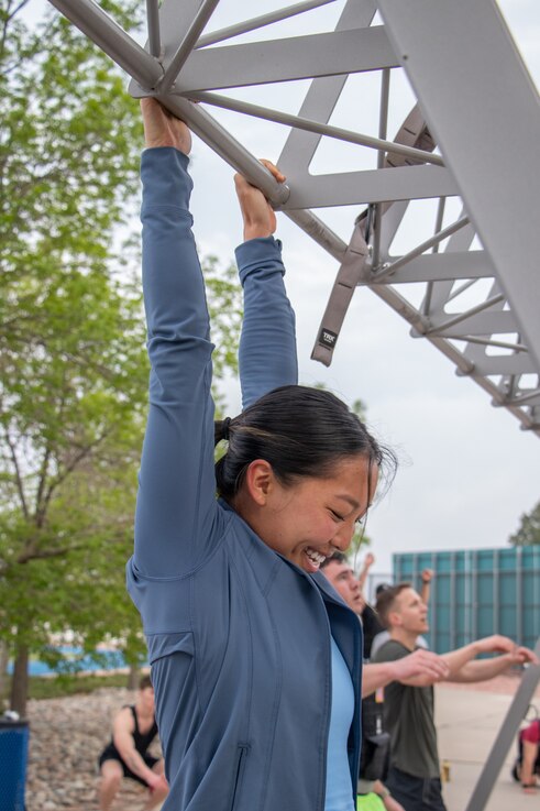  A member of Delta 3 catches her breath as she completes one of 200 pull-ups during the Delta's Memorial Day workout.