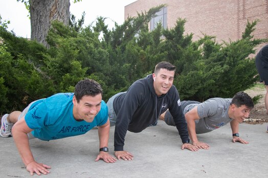  Three members from Delta 3-Space Electromagnetic Warfare complete push-ups during the group's Memorial Day workout.