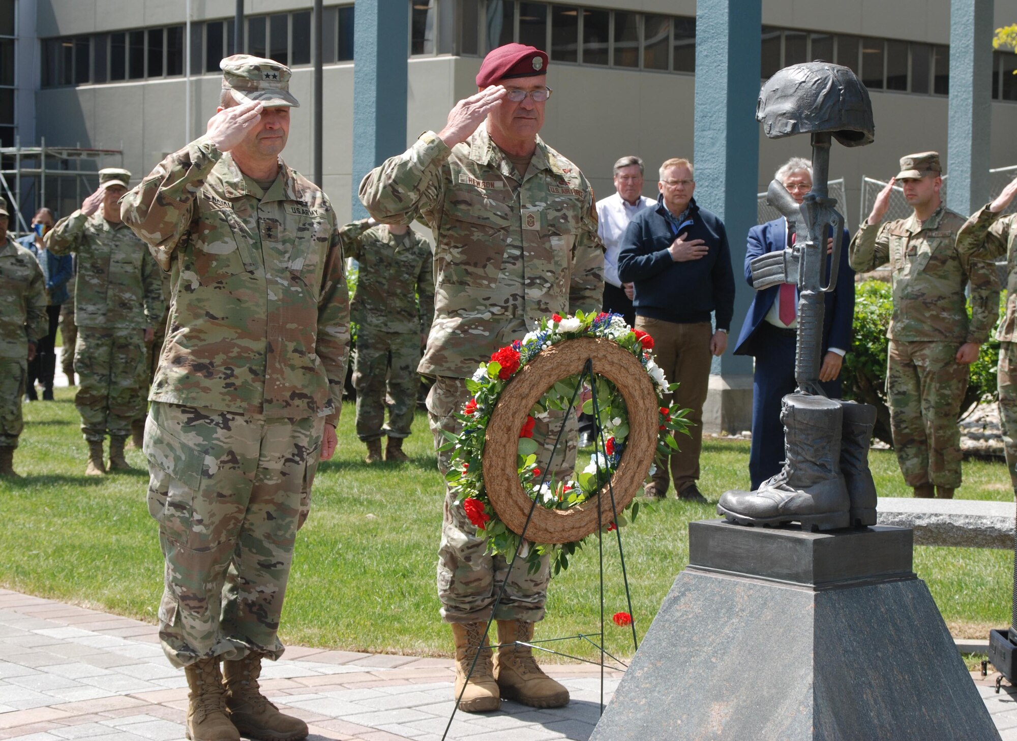 New York Army National Guard Maj. Gen. Michele Natali, left, the assistant adjutant general, Army; and New York Air National Guard Command Chief Master Sgt. Michael Hewson, the senior enlisted advisor for the New York Air National Guard, salute following the presentation of a wreath during a Memorial Day ceremony at New York National Guard headquarters in Latham, New York, May 25, 2023. The names of 12 members of the New York Military Forces and civilian employees of the New York State Division of Military and Naval Affairs who have died in the past year were also read during the ceremony.