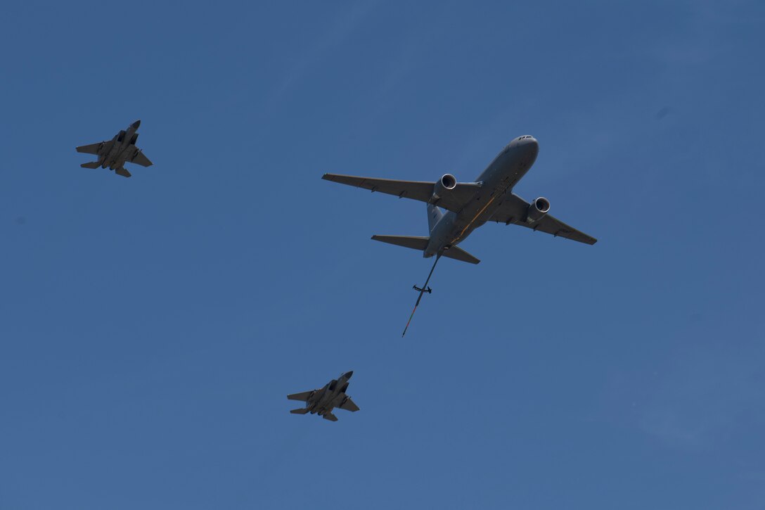 Two U.S. Air Force F-15C Eagles, with the 104th Fighter Wing, Massachusetts Air National Guard, trail behind a KC-46 Pegasus, with the 157th Air Refueling Wing, New Hampshire Air National Guard, while performing an aerial demonstration during the 2023 Westfield International Air Show at Barnes Air National Guard Base, Massachusetts, May 13, 2023. The two-day event allowed the 104th Fighter Wing and joint-service partners to strengthen their community ties with over 70,000 members of the public by showcasing their capabilities, aircraft and equipment. (U.S. Air National Guard photo by Staff Sgt. Hanna Smith)