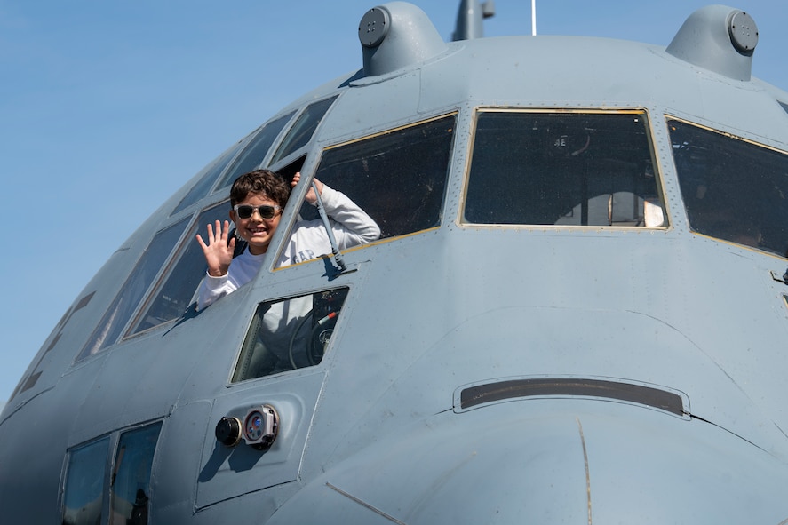 A child waves from a U.S. Air Force C-130 Hercules, Connecticut Air National Guard, assigned to the 103rd Airlift Wing, while on static display during the 2023 Westfield International Air Show at Barnes Air National Guard Base, Massachusetts, May 14, 2023. The two-day event allowed the 104th Fighter Wing and joint-service partners to strengthen their community ties with over 70,000 members of the public by showcasing their capabilities, aircraft and equipment. (U.S. Air National Guard photo by Staff Sgt. Hanna Smith)