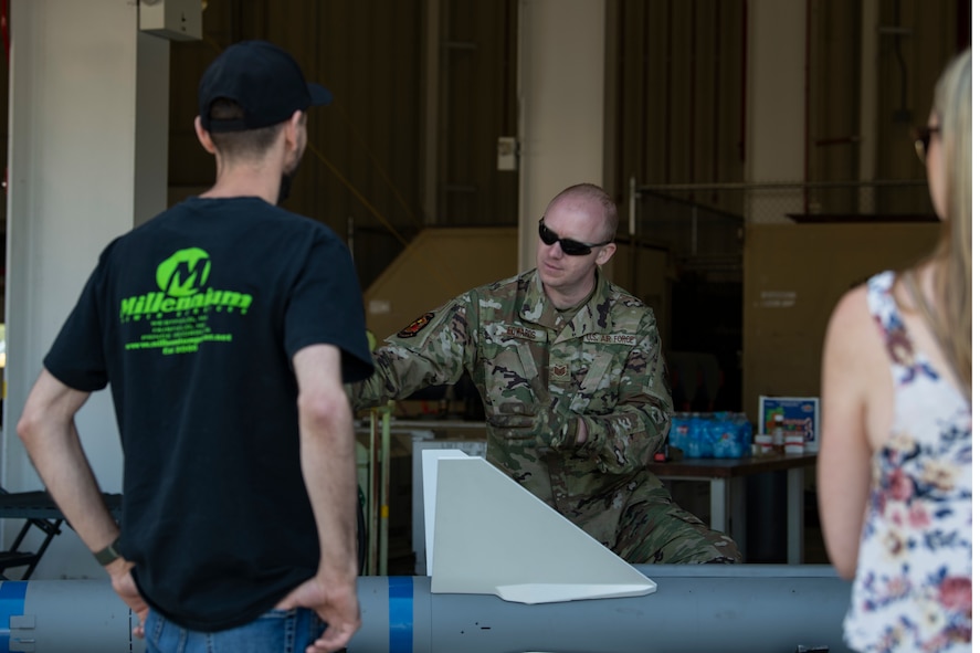 U.S. Air Force Tech. Sgt. Jesse Edwards, a munitions systems specialist with the 104th Maintenance Group, educates the public on a munitions system during the 2023 Westfield International Air Show at Barnes Air National Guard Base, Massachusetts, May 14, 2023. The two-day event allowed the 104th Fighter Wing and joint-service partners to strengthen their community ties with over 70,000 members of the public by showcasing their capabilities, aircraft and equipment. (U.S. Air National Guard photo by Staff Sgt. Hanna Smith)