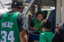 A child smiles while sitting in a Civil Air Patrol aircraft static display during the 2023 Westfield International Air Show at Barnes Air National Guard Base, Massachusetts, May 14, 2023. The two-day event allowed the 104th Fighter Wing and joint-service partners to strengthen their community ties with over 70,000 members of the public by showcasing their capabilities, aircraft and equipment. (U.S. Air National Guard photo by Staff Sgt. Hanna Smith)