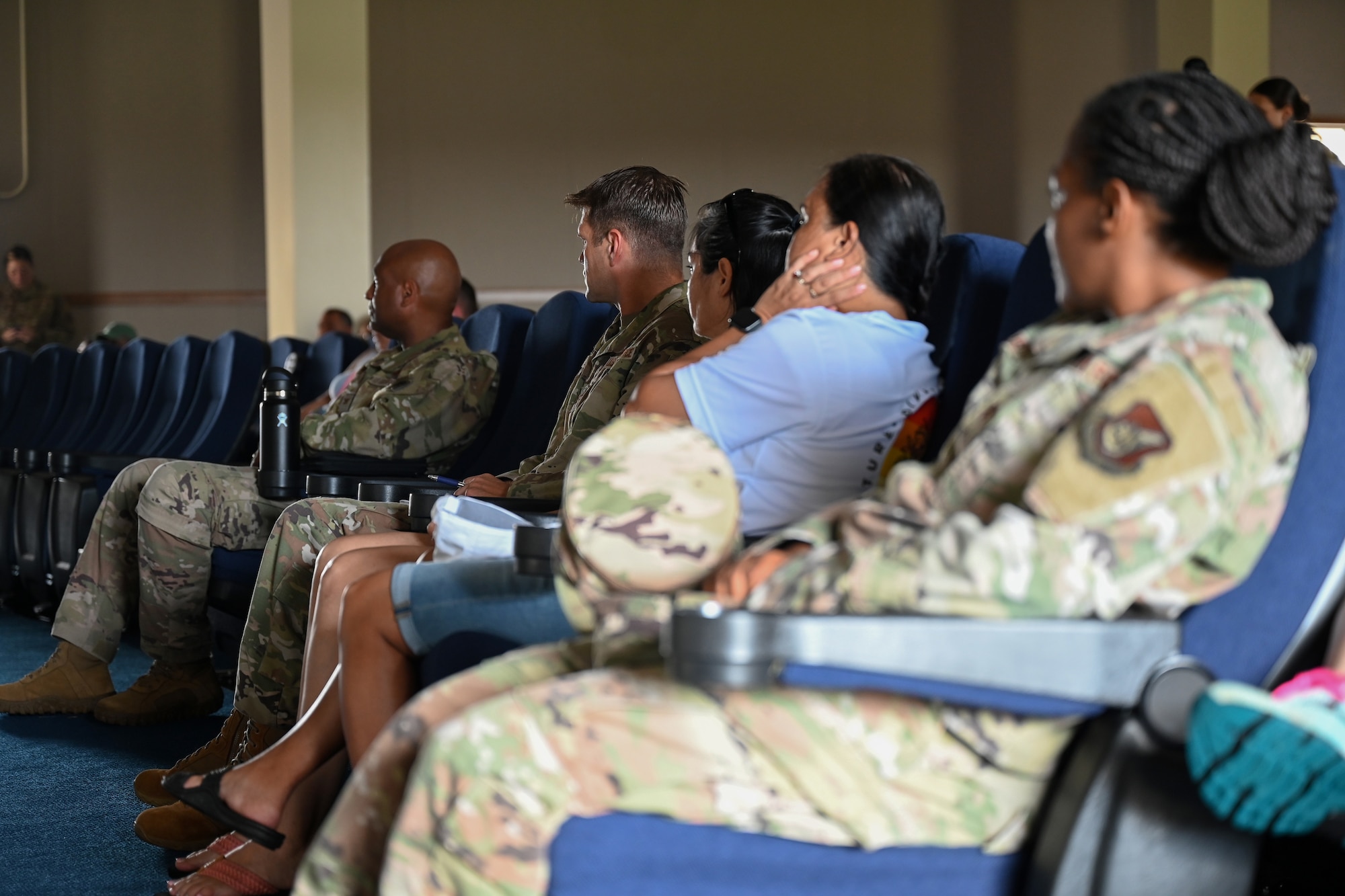 U.S. Air Force service members, civilian employees and dependents listen to base condition updates during a town hall following Super Typhoon Mawar at Andersen Air Force Base, Guam, May 29, 2023. Fast discussed recovery priorities on base; command, control and communication, sustainment of life, open airfield, helping the community of Guam and recovering facilities. (U.S. Air Force photo by Senior Airman Kaitlyn Preston)