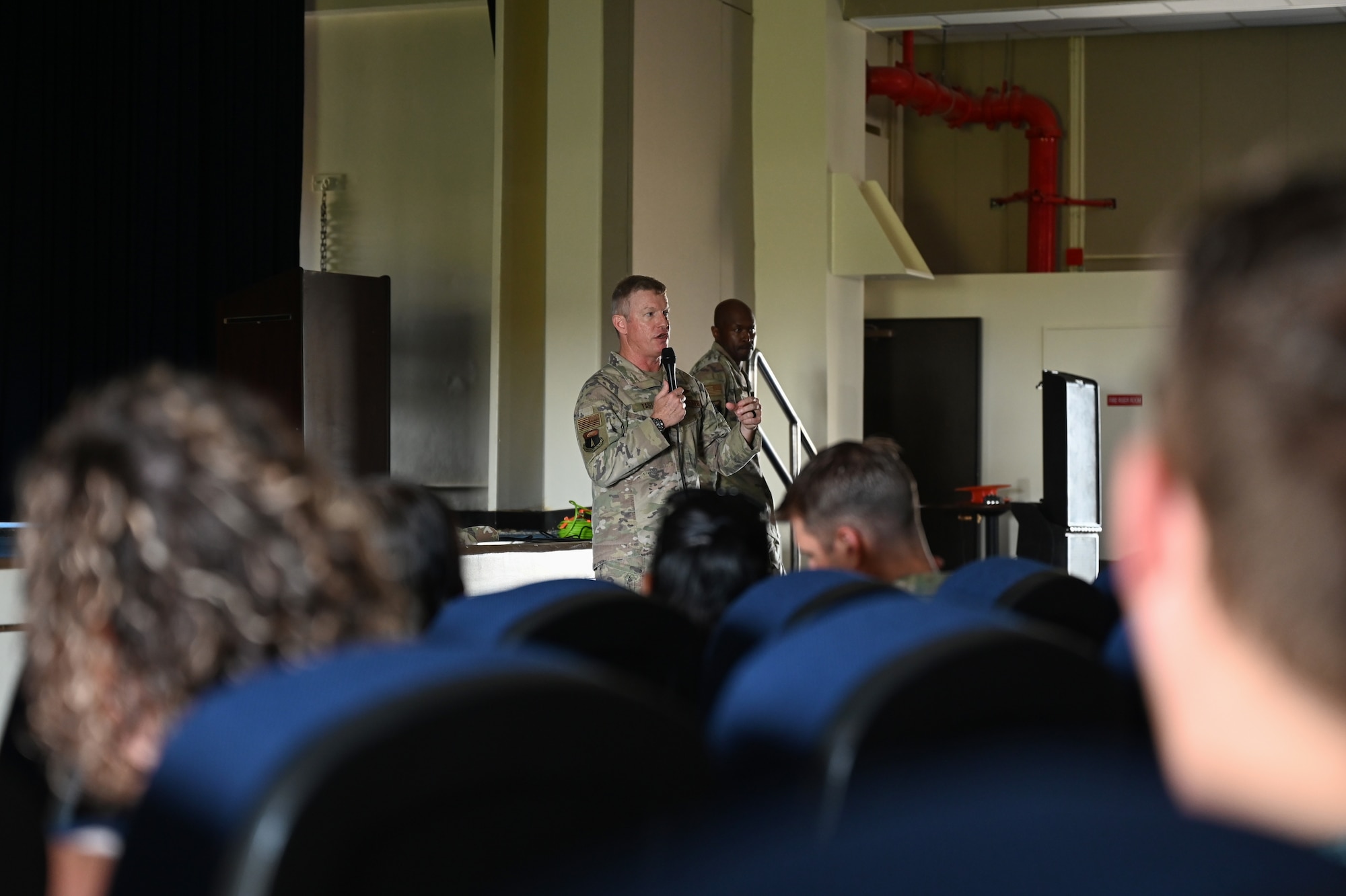 U.S. Air Force Brig. Gen. Paul Fast, 36th Wing commander, updates members of Team Andersen on current conditions during a town hall meeting about Super Typhoon Mawar at Andersen Air Force Base, Guam, May 29, 2023. Fast discussed recovery priorities on base and the recovery progress since the storm. (U.S. Air Force photo by Senior Airman Kaitlyn Preston)