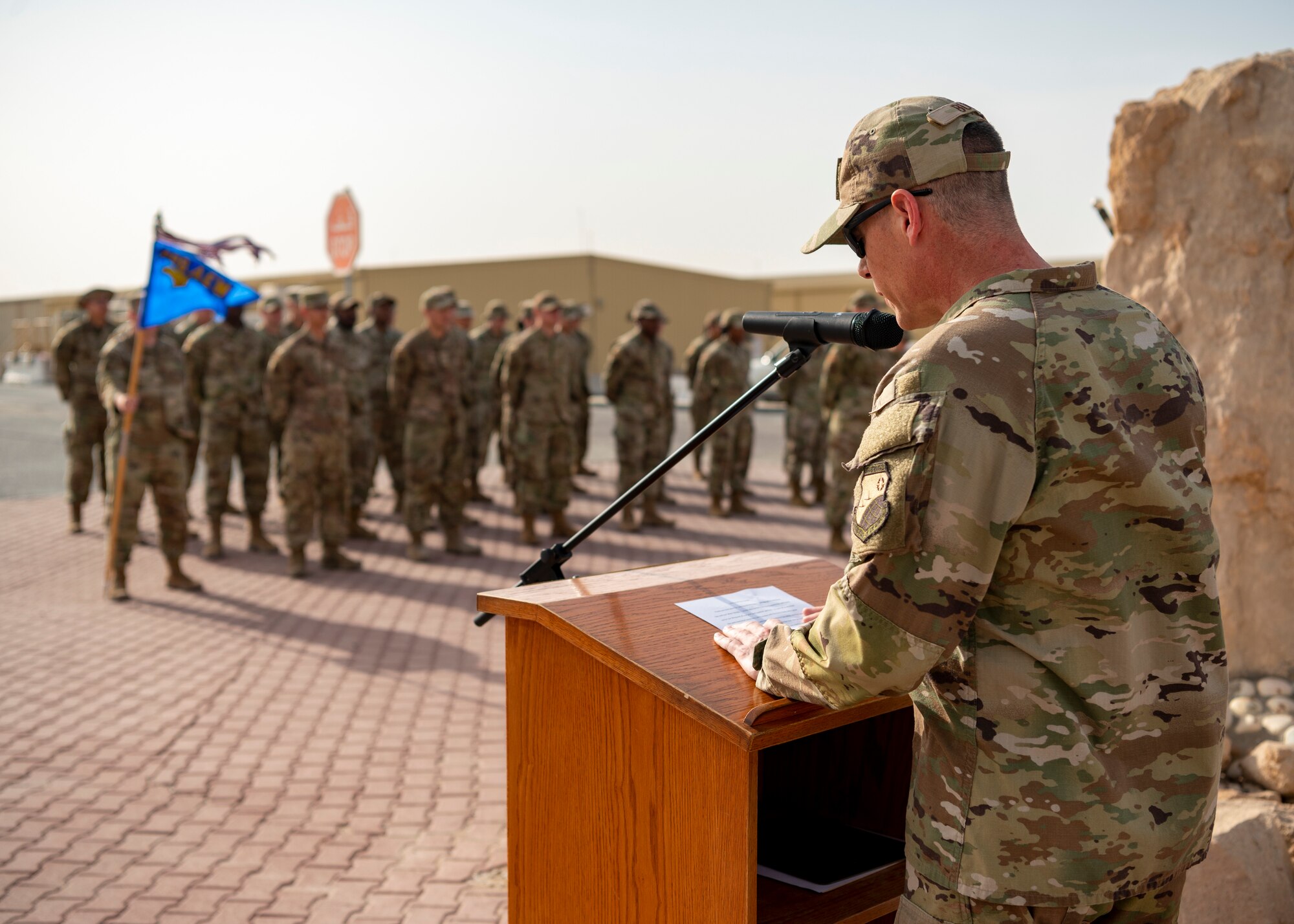 U.S. Air Force Wing commander stands at podium and reads names of fallen service members, in honor of Memorial Day.