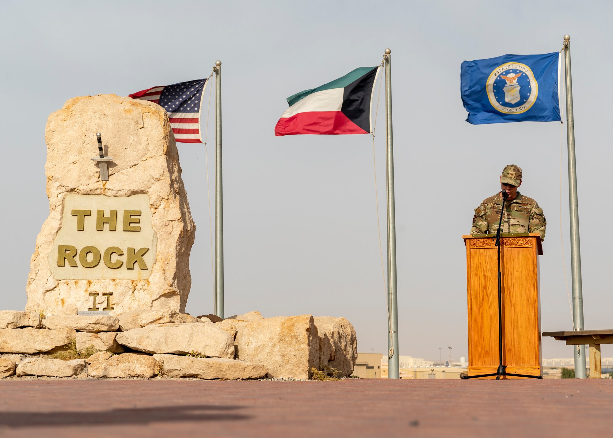 U.S. Air Force Wing commander stands at podium and reads names of fallen service members, in honor of Memorial Day.