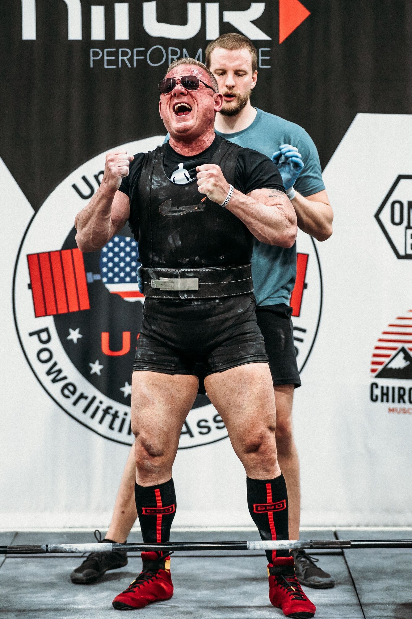 A man stand with fists clenched in victory