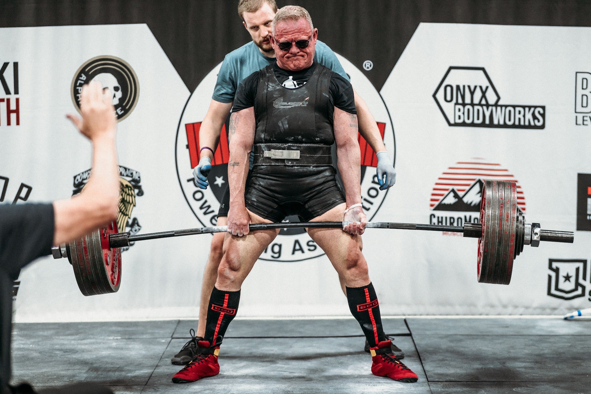 A man lifts a heave bar with weights