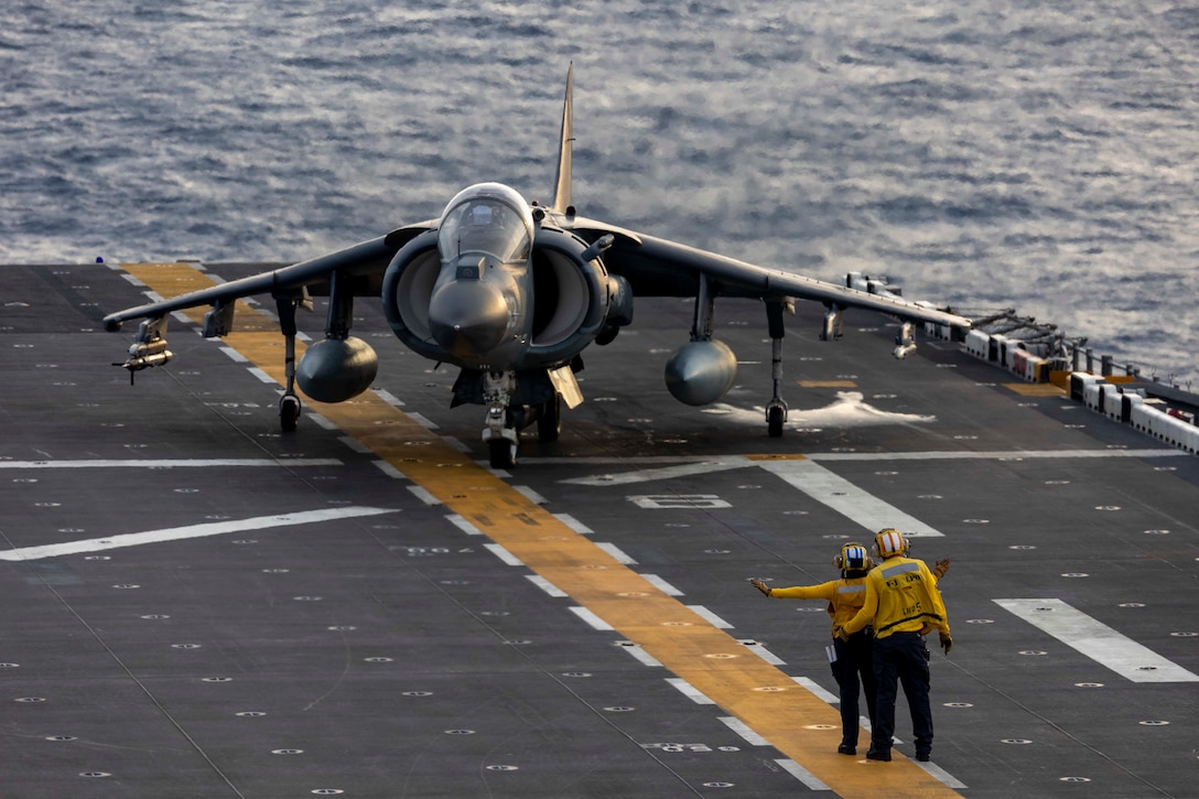ATLANTIC OCEAN (May 17, 2023) Air Department Sailors assigned to the Wasp-class amphibious assault ship USS Bataan (LHD 5) signal to an AV-8B Harrier, assigned to Marine Medium Tilt Rotor Squadron 162 (reinforced), on the flight deck of the Wasp-class amphibious assault ship USS Bataan (LHD 5). The Bataan Amphibious Ready Group and 26th Marine Expeditionary Unit are underway participating in the Carrier Strike Group Four Composite Training Unit Exercise (COMPTUEX). COMPTUEX is the final pre-deployment exercise that certifies the Bataan ARG and 26th MEU’s ability to conduct military operations through joint planning, and execute challenging and realistic scenarios. (U.S. Navy photo by Mass Communication Specialist 2nd Class Danilo Reynoso)