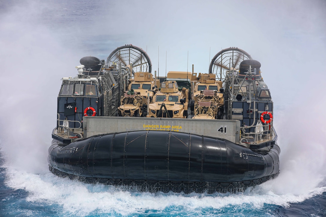 230526-N-ED646-3284- ATLANTIC OCEAN (May 26, 2023) A landing craft, air cushion, assigned to Assault Craft Unit 4, transits toward the well deck of the amphibious dock landing ship USS Carter Hall (LSD 50). The Bataan Amphibious Ready Group and 26th Marine Expeditionary Unit are underway participating in the Carrier Strike Group Four Composite Training Unit Exercise (COMPTUEX). COMPTUEX is the final pre-deployment exercise that certifies the Bataan ARG and 26th MEU's ability to conduct military operations through joint planning, and execute challenging and realistic scenarios. (U.S. Navy photo by Mass Communication Specialist 3rd Class Moises Sandoval)