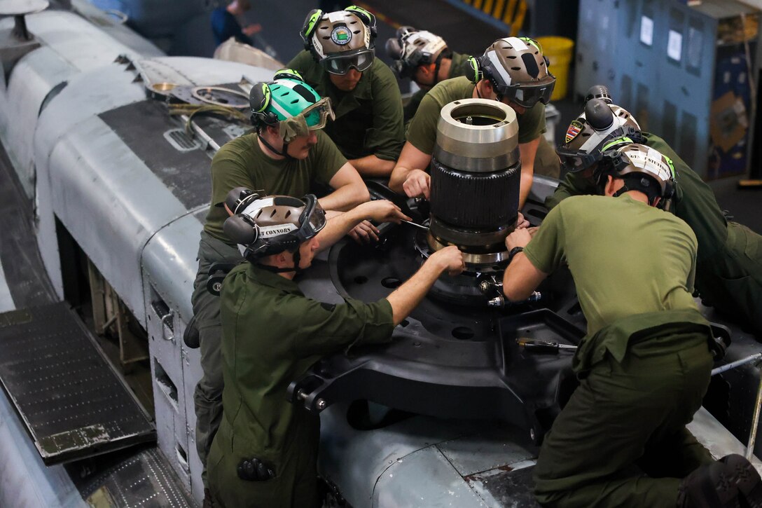 ATLANTIC OCEAN (May 26, 2023) Marines assigned to the 26th Marine Expeditionary Unit (MEU) attach a swash plate to a CH-53E Super Stallion, assigned to Marine Medium Tilt Rotor Squadron 162 (reinforced), aboard the Wasp-class Amphibious Assault Ship USS Bataan (LHD 5). The Bataan Amphibious Ready Group and 26th MEU are underway participating in the Carrier Strike Group Four Composite Training Unit Exercise (COMPTUEX). COMPTUEX is the final pre-deployment exercise that certifies the Bataan ARG and 26th MEU’s ability to conduct military operations through joint planning, and execute challenging and realistic scenarios. (U.S. Navy Photo by Mass Communication Specialist 3rd Class Riley Gasdia)