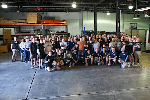 Annual Port Dawg Memorial Run participants pose for a group photo at Niagara Falls Air Reserve Station, New York on May 5, 2023.