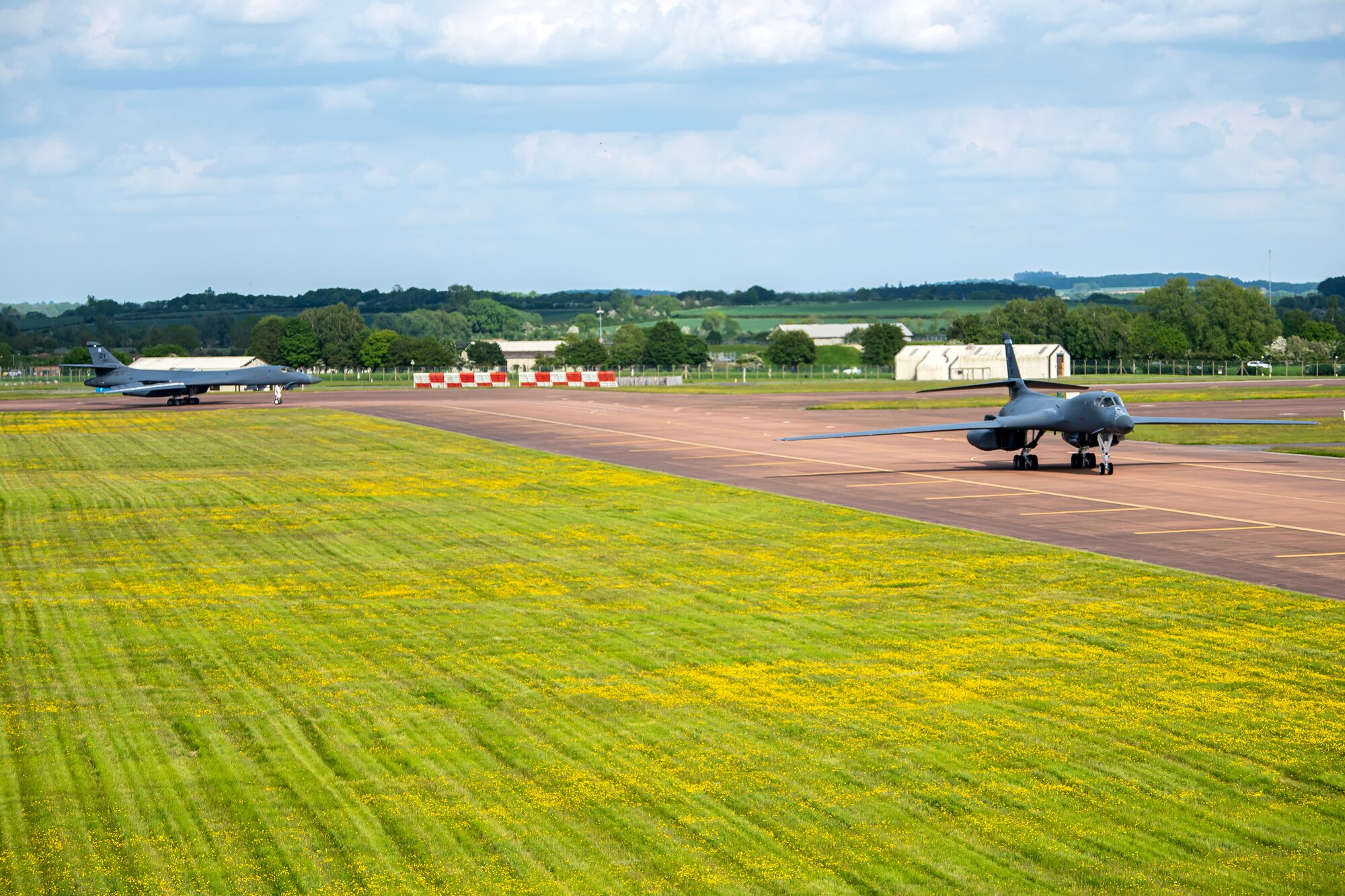 Two B-1B Lancers from the 9th Expeditionary Bomb Squadron taxi on the runway at RAF Fairford, United Kingdom, May 23, 2023 for Bomber Task Force Europe 23-3. Strategic bombers contribute to stability in the European theater, as they are intended to deter conflict rather than instigate. If called upon, U.S. bombers offer a rapid response capability. (U.S. Air Force photo by Staff Sgt. Eugene Oliver)