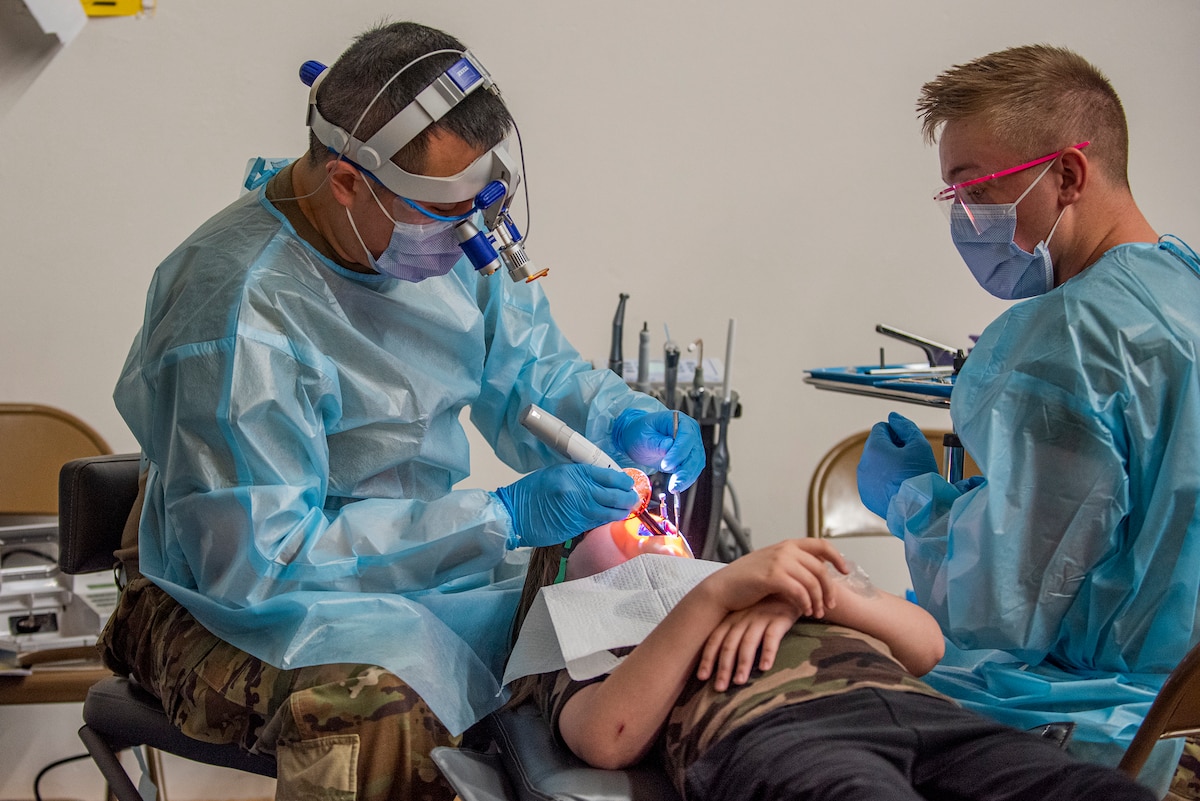 Image of Soldiers and Airmen providing medical care.