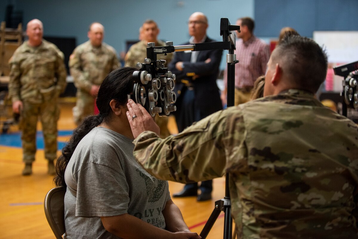 Image of Soldiers and Airmen providing medical care.