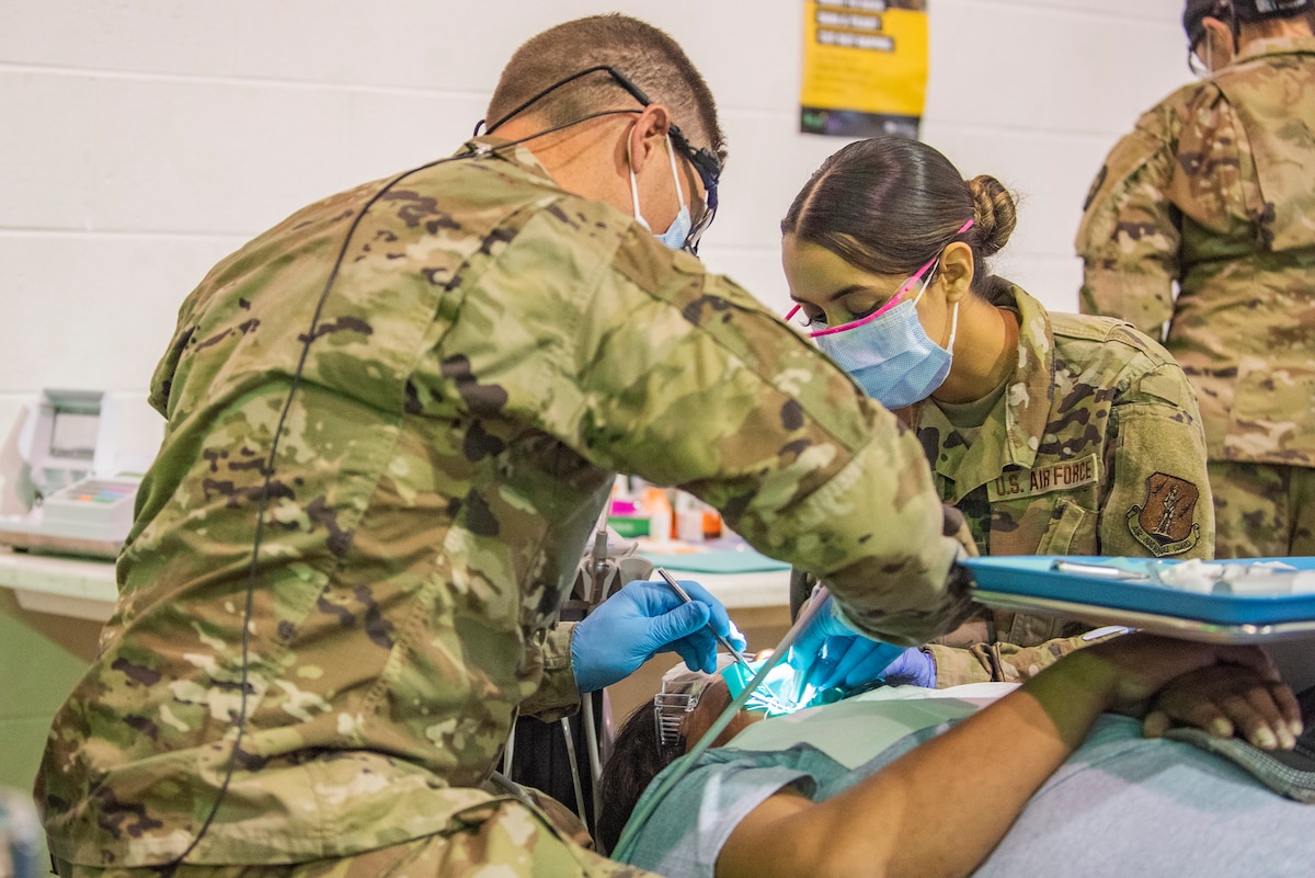 Image of Soldiers and Airmen providing medical care.