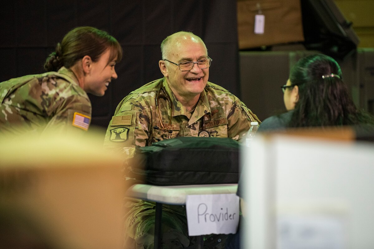 Image of Soldiers and Airmen providing medical care.