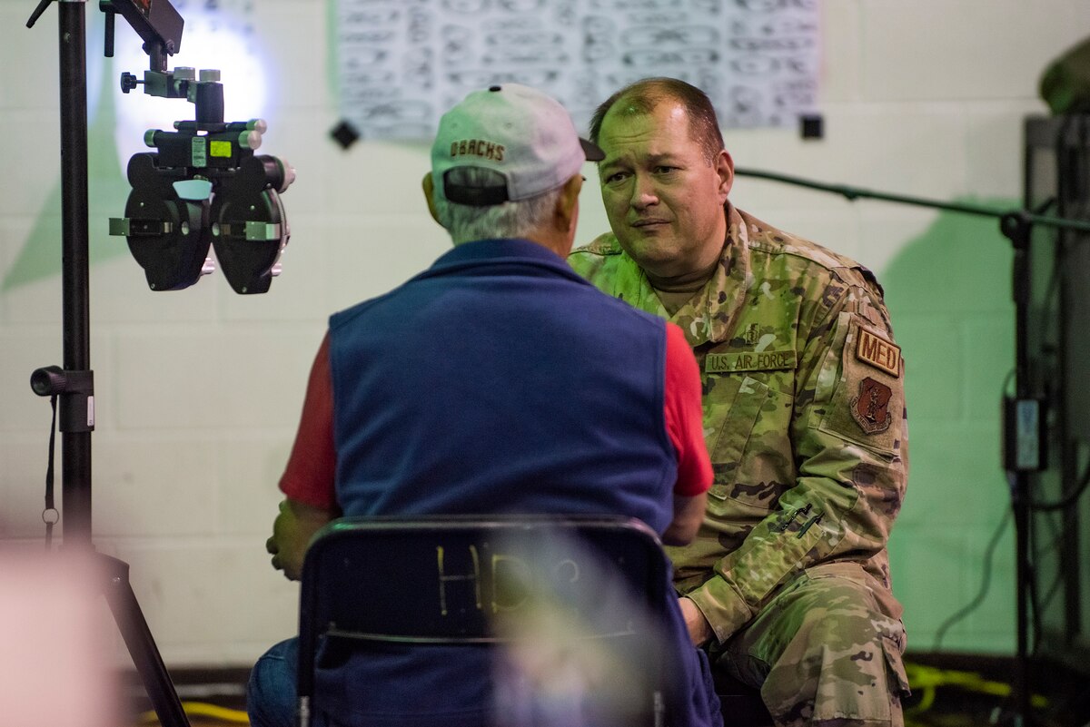 Image of Soldiers and Airmen providing medical care.