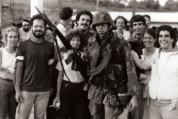 Soldier and Students: American students at St. George University on Grenada surround a U.S. Soldier after his arrival at the campus with peacekeeping forces. (1983)