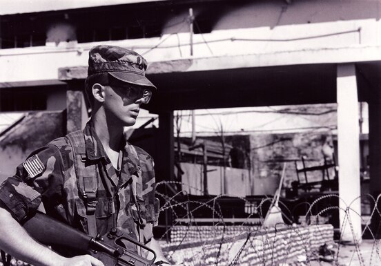 A U.S. soldier stands guard outside a Panamanian military headquarters during Operation Just Cause. (1989)
