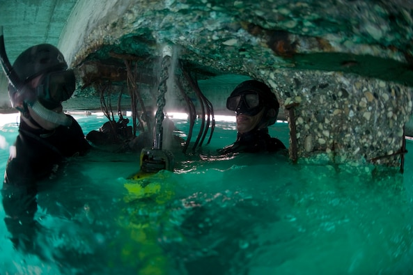 Army and Navy divers drill guide holes into a damaged section of pier. U.S. military divers helped repair the main seaport of Port-au-Prince, Haiti, as part of the humanitarian and disaster relief to Haiti. (DoD Photo)