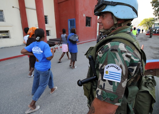 A UN Peacekeeper from Uruguay provides security at a food distribution point in Haiti in 2010.