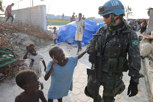 A UN peacekeeper from Brazil talks to children in Haiti in 2010. The U.S. military deployed over 22,000 personnel to Haiti to save lives and mitigate suffering following an earthquake on 12 January.  (Source: U.S. Southern Command)