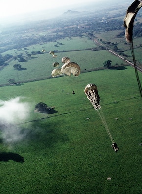 Soldiers of 1st Battalion, 509th Infantry, parachute from a C-130E Hercules aircraft into a drop zone outside the city to conduct operations in support of Operation Just Cause in Panama in 1989.