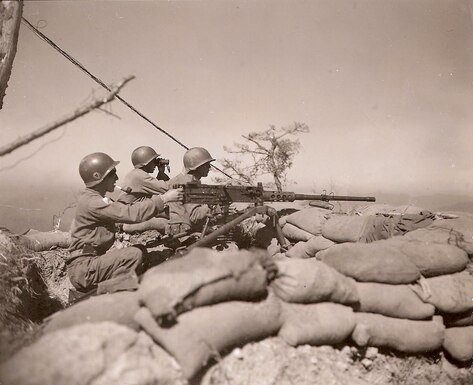 Colombian troops fire a .50-caliber machine gun at an enemy position in central Korea, October 1951.  During the Korean War, the U.S. Caribbean Command supported the Colombian military deployment with training and equipment.  (Source: U.S. Army Signal Corps, NARA)