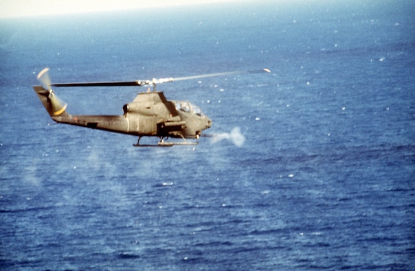 A U.S. Army AH-1 Cobra helicopter firing its 20mm cannon during a mission in support of Operation Urgent Fury in Grenada in 1983. (DoD photo)