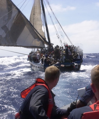 A boarding team from Coast Guard Cutter FORWARD, approaches a vessel containing 380 Haitian migrants in the Windward Passage, April 23, 2004.