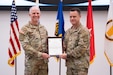 Col. Anthony Gibbs receives the Army Acquisition Corps flag from Brig. Gen. Christopher Schneider, signifying his assumption as Project Manager Soldier Warrior, during a change of charter ceremony at Fort Belvoir, Virginia, May, 25, 2023. (U.S. Army Photo by Jason Amadi, PEO Soldier Public Affairs)