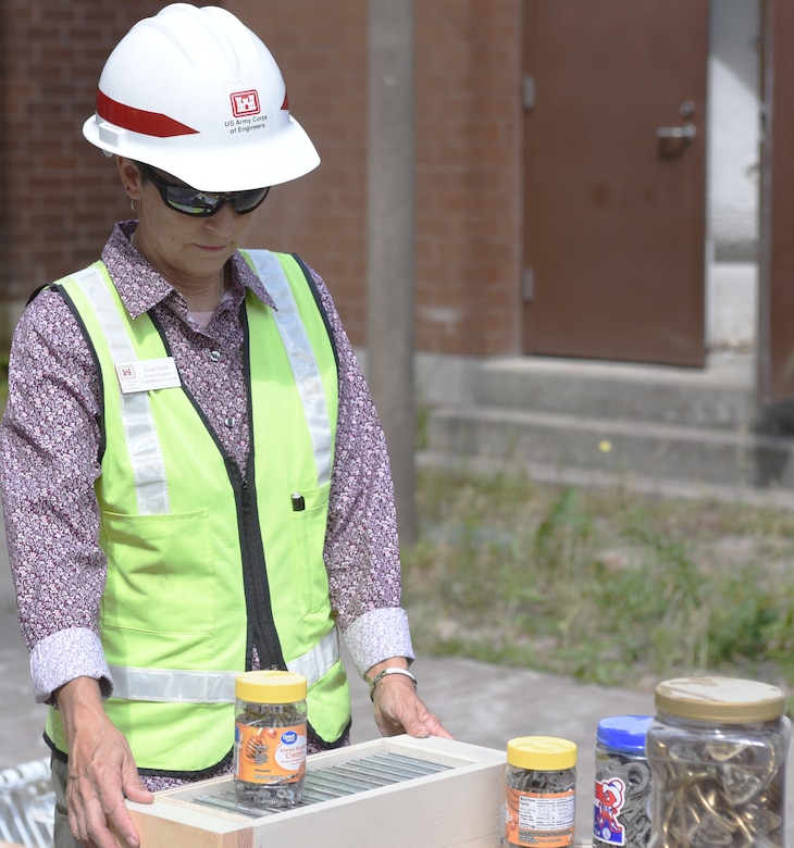 Susan Smith, U.S. Army Corps of Engineers, Savannah District, project engineer, at Fort Stewart organizes the nuts, bolts, screws and other hardware that go with the doors, cabinets and other items removed from Building 633, a military construction barracks renovation. The items were donated to ReStore of The Coastal Empire Habitat for Humanity, Inc., to be repurposed at various locations in Georgia.