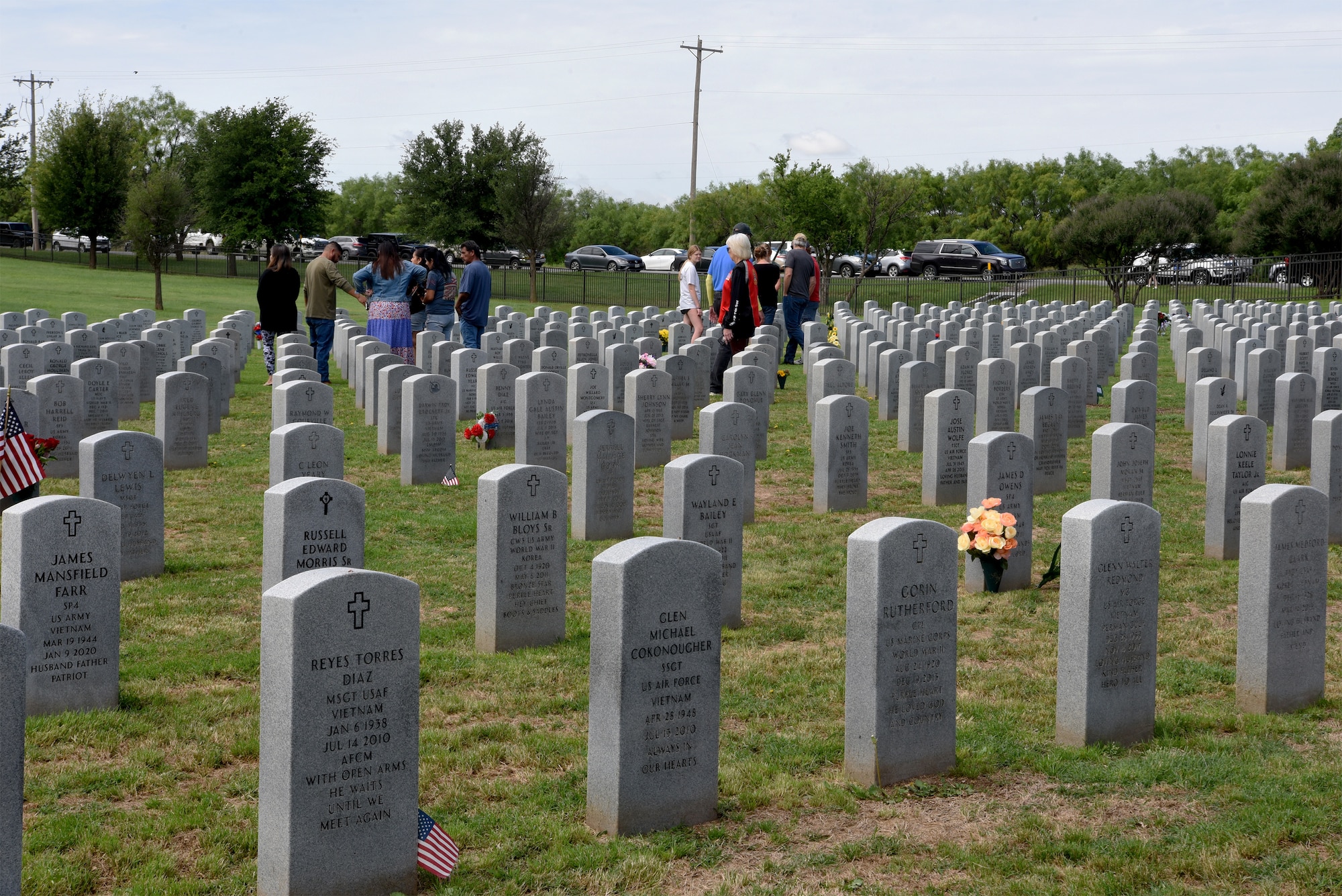 Members of the Abilene community pay their respects to the deceased after the Memorial Day service at the Texas State Veterans Cemetery in Abilene, Texas, May 29, 2023. Memorial Day is a time to honor the ultimate sacrifice of the service members that gave their lives in defense of the United States. (U.S. Air Force photo by Senior Airman Sophia Robello)
