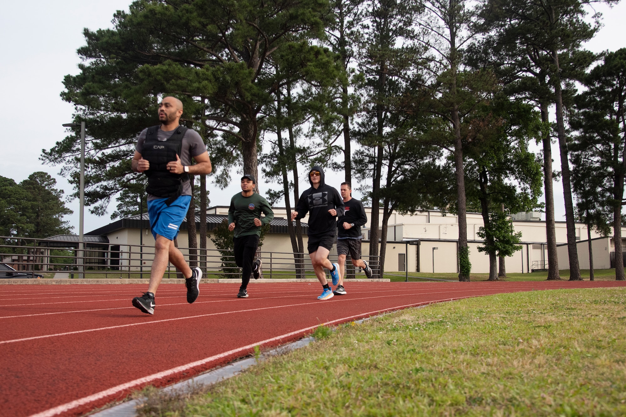Airmen run down a track as part of the annual Murph Challenge at Seymour Johnson Air Force Base, North Carolina, May 25, 2023. Participants tested their physical and mental resilience to complete a 1-mile run, 100 pull ups, 200 push-ups, 300 air squats, and a culminating 1-mile run, with some members donning a weighted vest, during the challenge. Members of Team Seymour participated in the annual event as a way to celebrate the memory of U.S. Navy Seal Lieutenant Michael Murphy, who paid the ultimate sacrifice for his country in 2005. (U.S. Air Force photo by Tech. Sgt. Christopher Hubenthal)