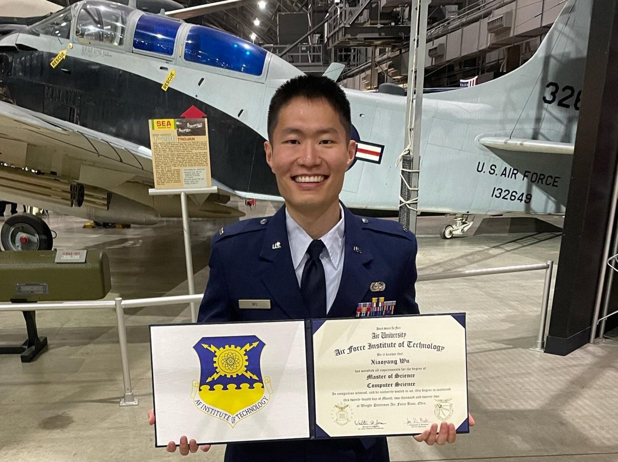 1st Lt. Xiaoyang Wu, Joint Mission Operations Center watch officer for the 367th Cyberspace Operations Squadron, displays his Master of Science degree March 24, 2022, at the National Museum of the United States Air Force, Wright -Patterson Air Force Base, Ohio. “Being an officer has given me the opportunity to realize why I came back into the Air Force on Active Duty,” said Wu. “It’s not the mission, it’s not the job. The job is not always glamourous. It’s the people. The people is why I came back. I miss the comradery; I miss the friendship. I miss the instances that people will drop everything they have going on to help you. You don’t get that form of comradery, that bond in the civilian world, and I missed that.”