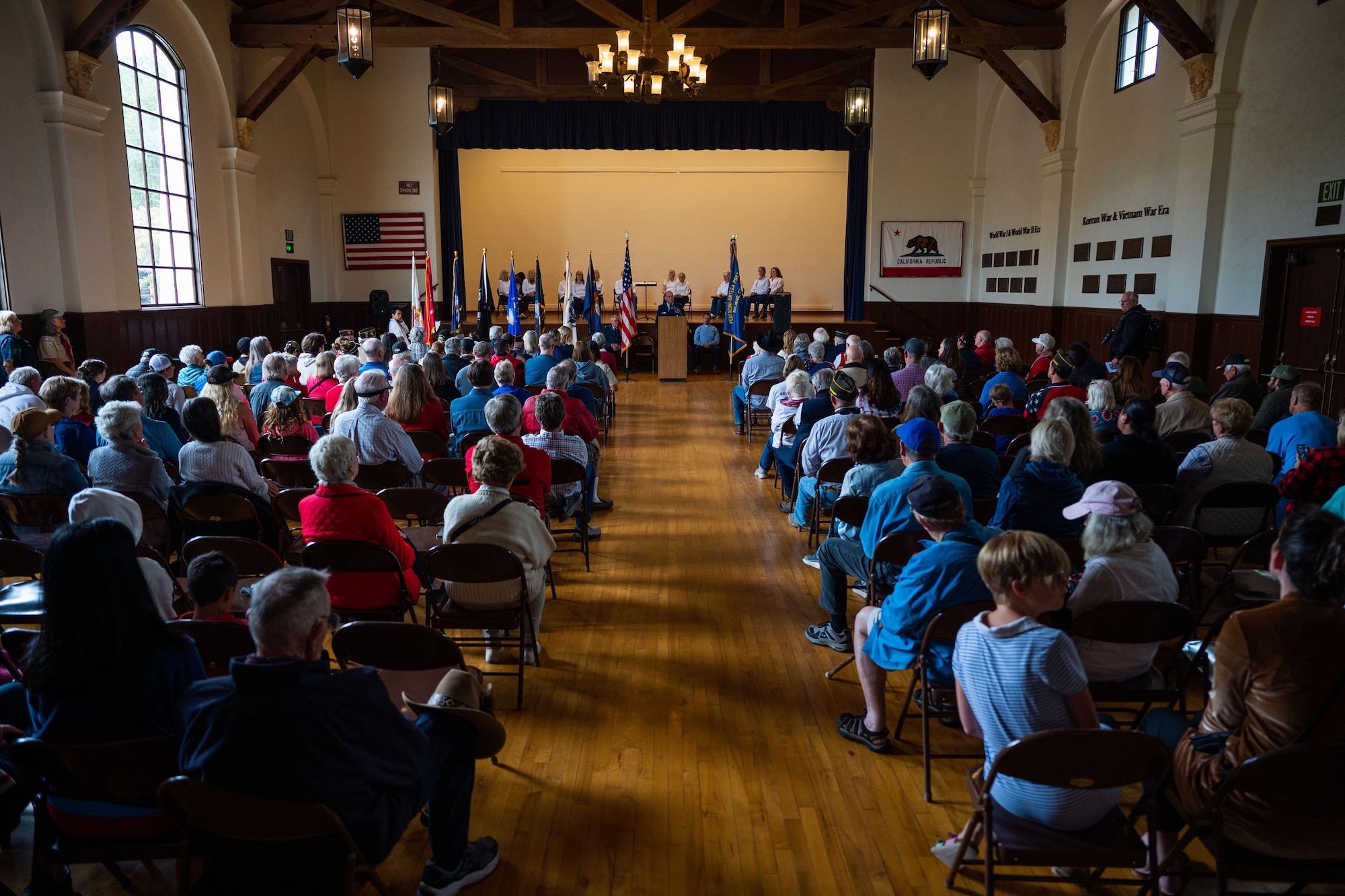 A member of a local scouts group particpates in the raising of the American flag during a Memorial Day ceremony at the Solvang Veterans Memorial Hall in Solvang, Calif., May 29, 2023. U.S. Space Force Maj. Gen. Douglas A. Schiess, Combined Force Space Component Command commander, delivers his keynote speech to over 200 attendees during a Memorial Day ceremony at the Solvang Veterans Memorial Hall in Solvang, Calif., May 29, 2023. The attendees included veterans from the Global War on Terrorism, Vietnam, Korea and even one veteran from WWII. The ceremony also included the raising on the American Flag by a local Cub Scouts group and a laying of a wreath with a Gold Star family member. (U.S. Space Force photo by Tech. Sgt. Luke Kitterman)