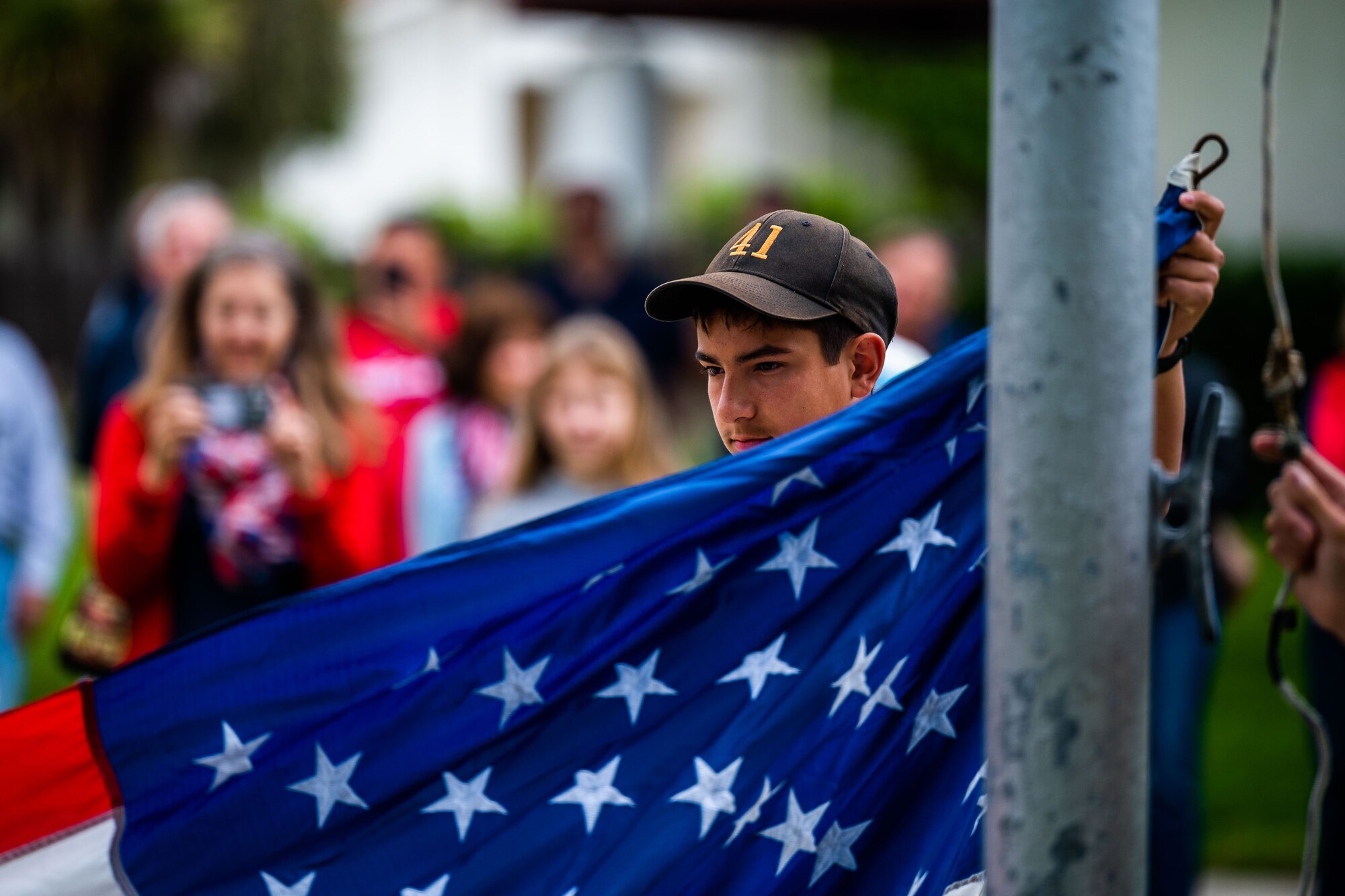 A member of a local scouts group particpates in the raising of the American flag during a Memorial Day ceremony at the Solvang Veterans Memorial Hall in Solvang, Calif., May 29, 2023. U.S. Space Force Maj. Gen. Douglas A. Schiess, Combined Force Space Component Command commander, gave the keynote speech to over 200 attendees that included veterans from the Global War on Terrorism, Vietnam, Korea and even one veteran from WWII. The ceremony also included the raising on the American Flag by a local Cub Scouts group and a laying of a wreath with a Gold Star family member. (U.S. Space Force photo by Tech. Sgt. Luke Kitterman)