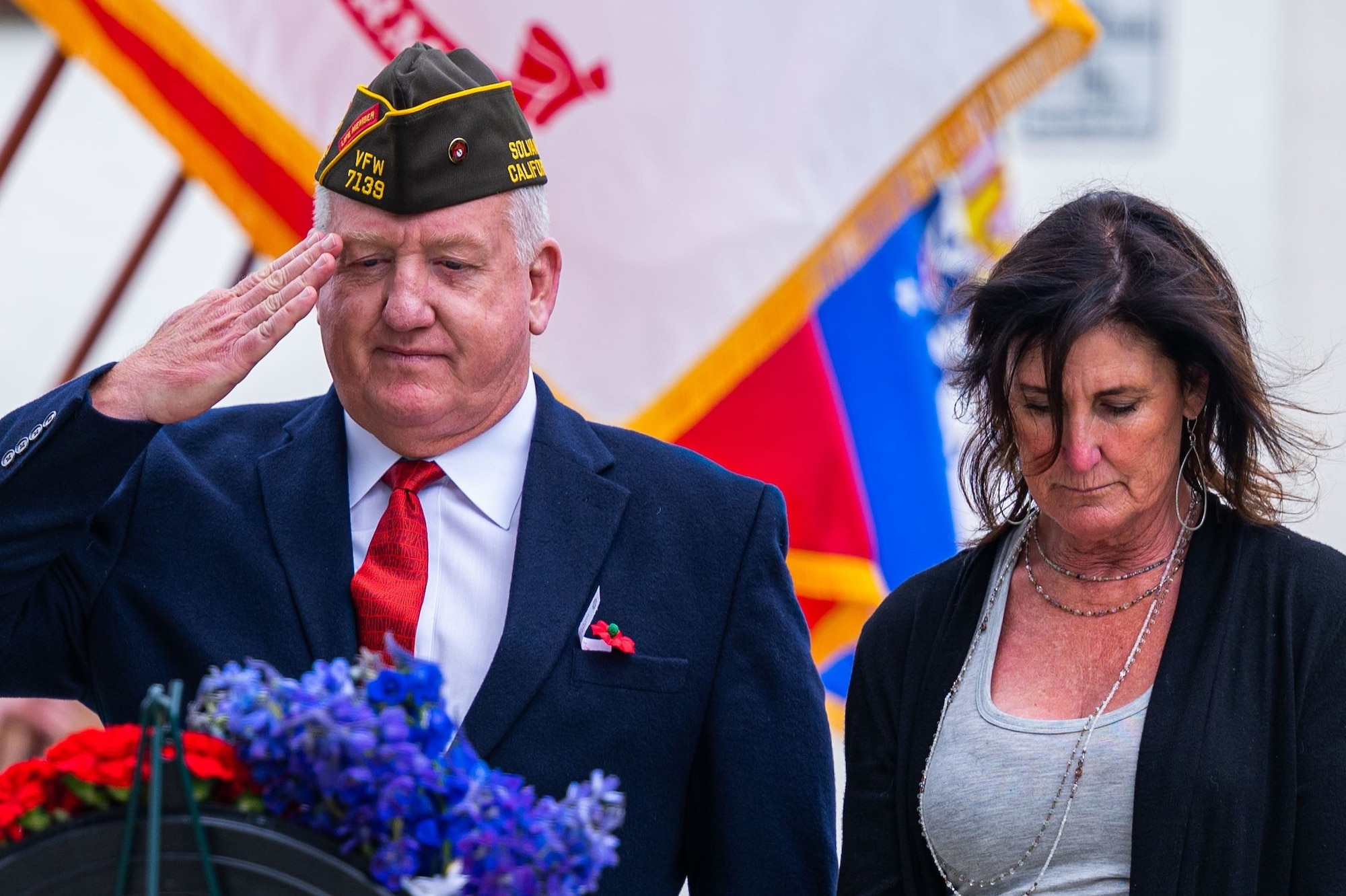 A veteran salutes while a Gold Star family member mourns during a Memorial Day ceremony at the Solvang Veterans Memorial Hall in Solvang, Calif., May 29, 2023. U.S. Space Force Maj. Gen. Douglas A. Schiess, Combined Force Space Component Command commander, gave the keynote speech to over 200 attendees that included veterans from the Global War on Terrorism, Vietnam, Korea and even one veteran from WWII. The ceremony also included the raising on the American Flag by a local Cub Scouts group and a laying of a wreath with a Gold Star family member. (U.S. Space Force photo by Tech. Sgt. Luke Kitterman)