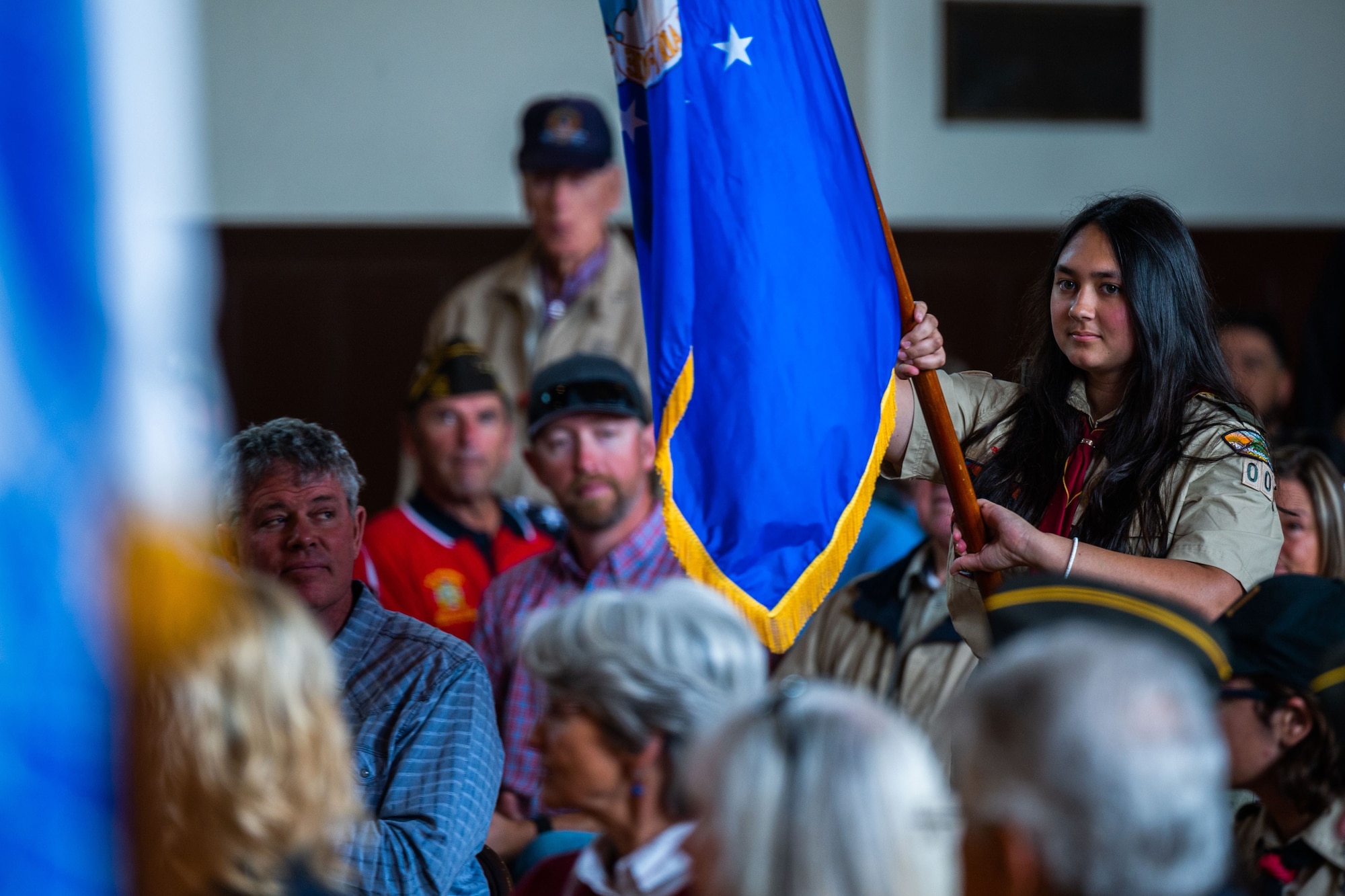 A member of a local scouts group carries the U.S. Air Force flag during a Memorial Day ceremony at the Solvang Veterans Memorial Hall in Solvang, Calif., May 29, 2023. U.S. Space Force Maj. Gen. Douglas A. Schiess, Combined Force Space Component Command commander, gave the keynote speech to over 200 attendees that included veterans from the Global War on Terrorism, Vietnam, Korea and even one veteran from WWII. The ceremony also included the raising on the American Flag by a local Cub Scouts group and a laying of a wreath with a Gold Star family member. (U.S. Space Force photo by Tech. Sgt. Luke Kitterman)