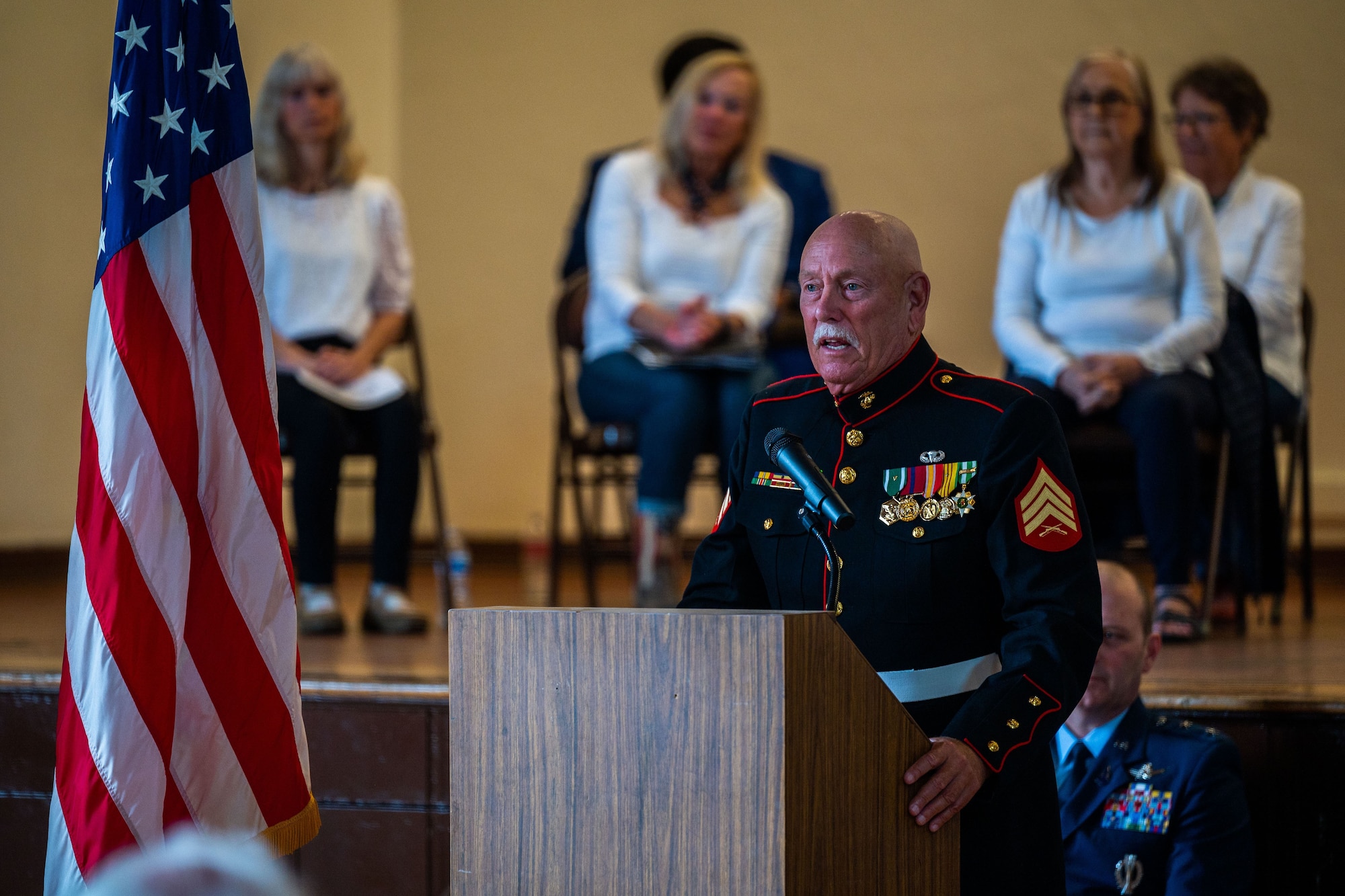 A U.S. Marine Veteran speaks to audience members during a Memorial Day ceremony at the Solvang Veterans Memorial Hall in Solvang, Calif., May 29, 2023. U.S. Space Force Maj. Gen. Douglas A. Schiess, Combined Force Space Component Command commander, and Mrs. Debbie Schiess, attended the Memorial Day ceremony where General Schiess gave the keynote speech to over 200 attendees that included veterans from the Global War on Terrorism, Vietnam, Korea and even one veteran from WWII. The ceremony also included the raising on the American Flag by a local Cub Scouts group and a laying of a wreath with a Gold Star family member. (U.S. Space Force photo by Tech. Sgt. Luke Kitterman)