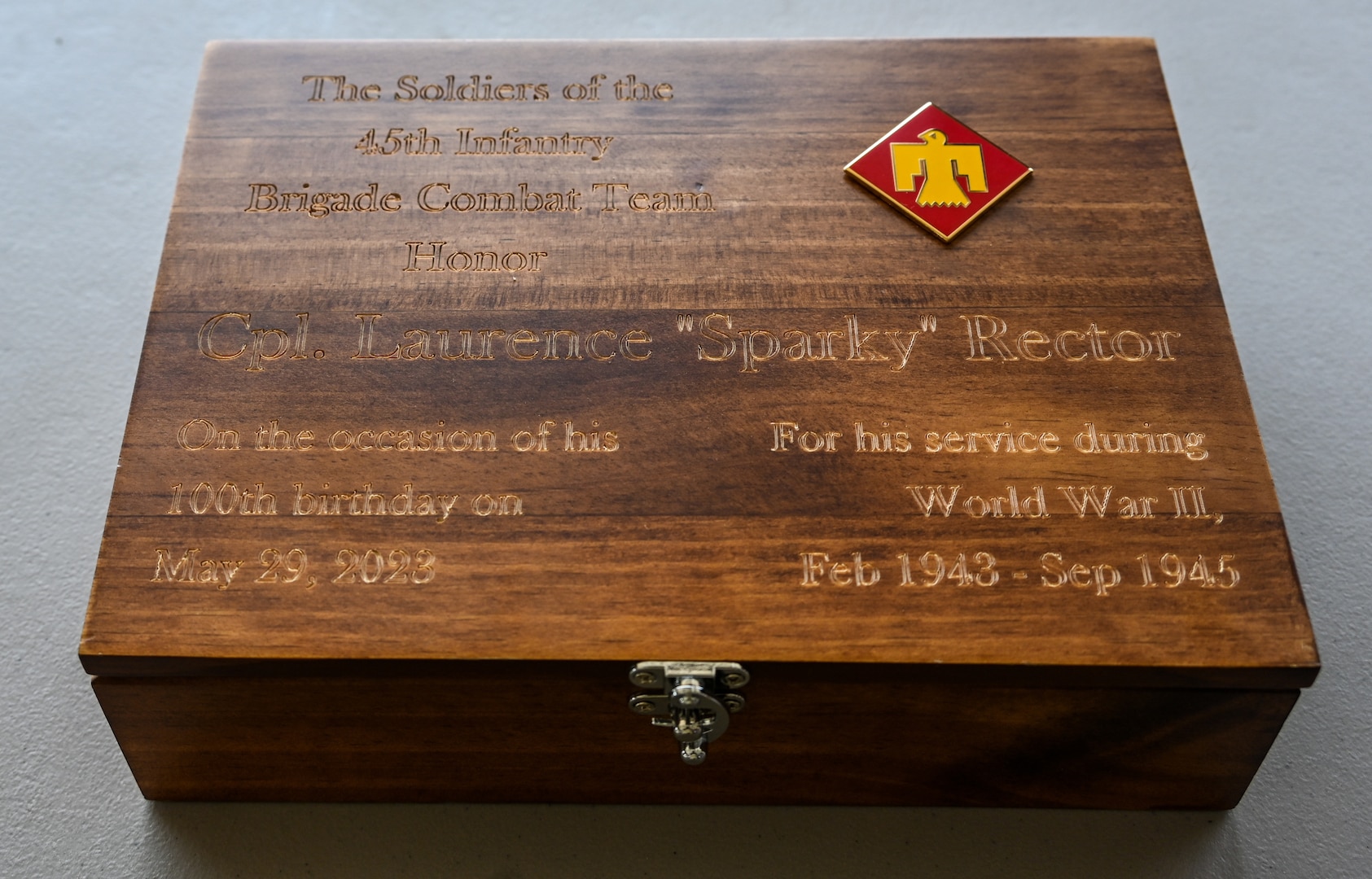 The custom box presented to Laurence “Sparky” Rector, a World War II veteran of the 45th Infantry Division at his 100th birthday party in  Mexico, N.Y., on May 27, presented by the Oklahoma Army National Guard's 45th Infantry Brigade. Rector fought through Europe with the 45th Division and  went on to be a successful wrestling coach and a beloved member of his community after the war. (New York National Guard photo by Staff Sgt. Matthew Gunther)