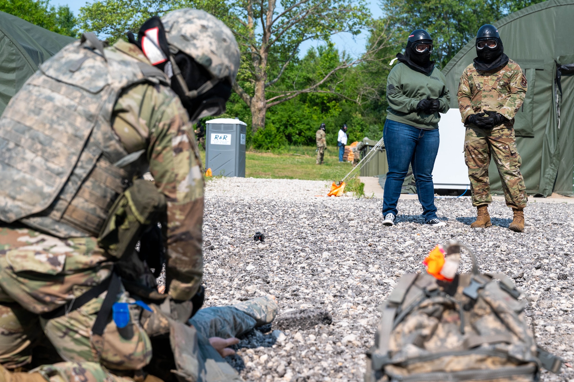 people watch Airmen perform first-aid training.