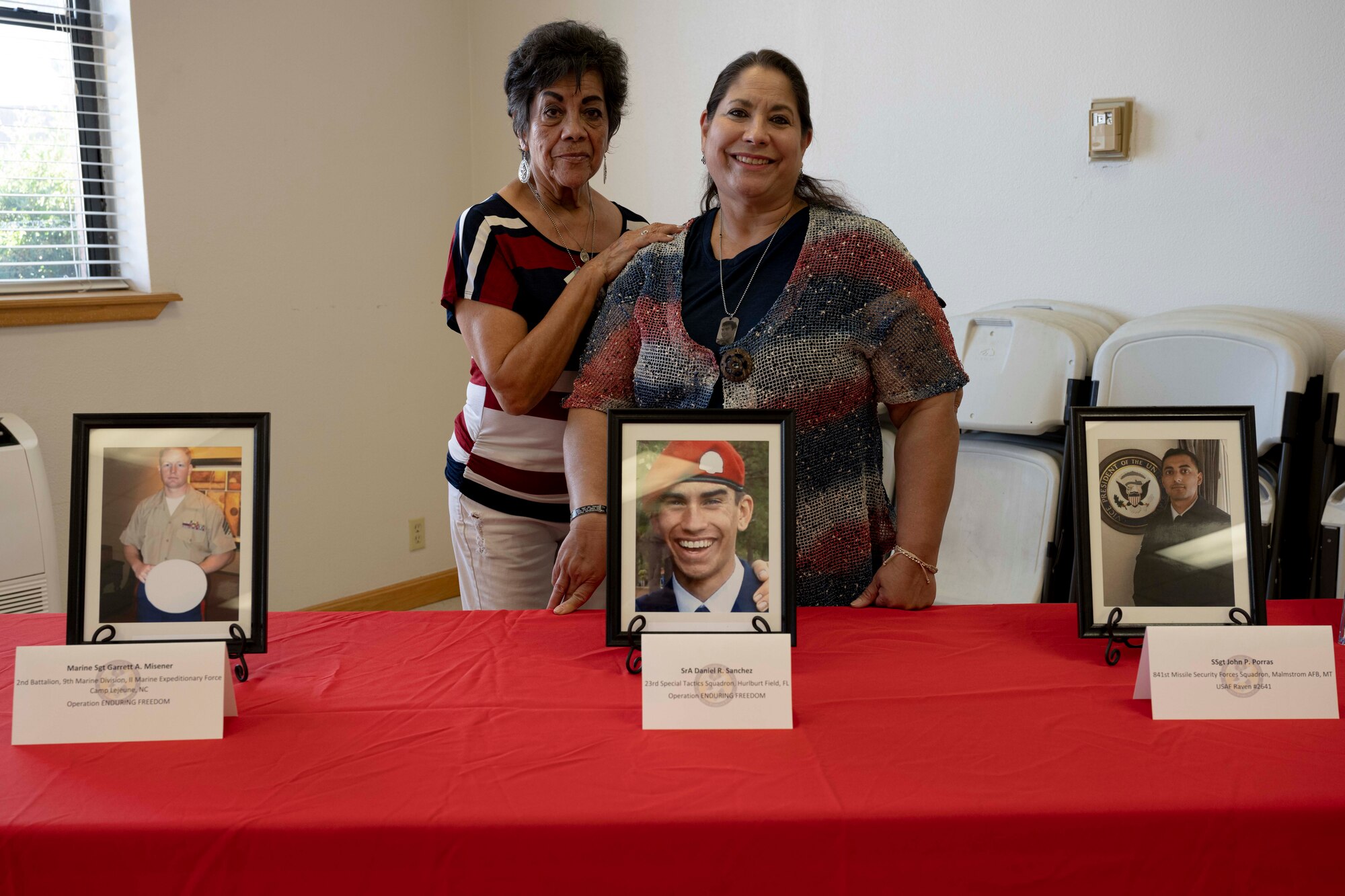 Yvette Sierra Duchene, Gold Star Mom, right, and Irene B. Sierra, Gold Star Grandmother stand behind a framed photo of U.S. Air Force Senior Airman Daniel Ray Sanchez, 23rd Special Tactics Squadron combat controller, at Holloman Air Force Base, New Mexico, May 25, 2023. When an active-duty service member dies, his or her mother automatically becomes a Gold Star Mother, a title that no mother wants, but it's one they wear proudly. (U.S. Air Force photo by Airman 1st Class Michelle Ferrari)