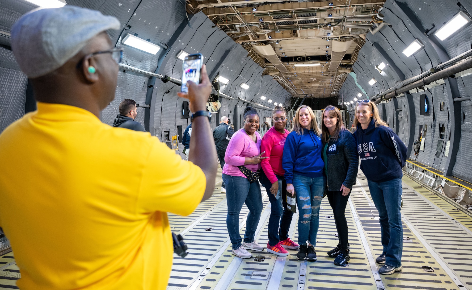 Members of the Central Delaware Chamber of Commerce Leadership Central Delaware program take photos aboard a C-5M Super Galaxy at Dover Air Force Base, Delaware, May 25, 2023. The LCD members were given the opportunity to see an aerial refueling training mission with the 9th Airlift Squadron, witnessing firsthand how Dover AFB trains to deliver cargo around the globe. (U.S. Air Force photo by Airman 1st Class Amanda Jett)